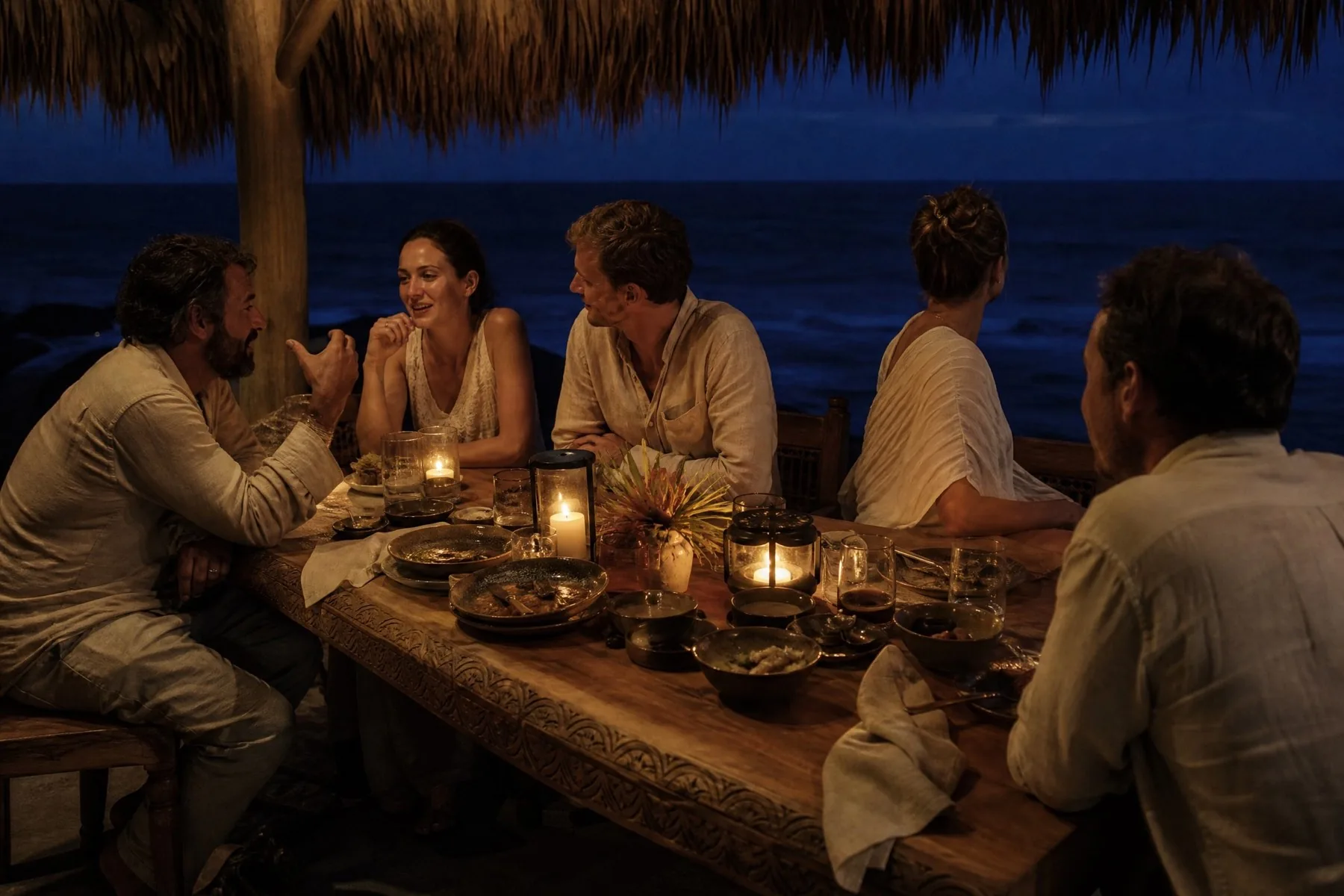 A long table set outdoors at dusk